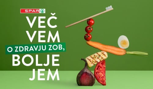 Slogan Več vem o zdravju zob, bolje jem in zloženka živil na zeleni podlagi
