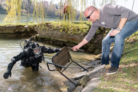 Potapljač je iz vode prinesel stol in močki na bregu ga je prijel